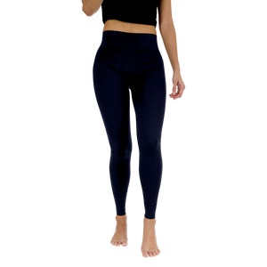Person wearing navy leggings on a white background