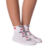 White ankle socks with a pattern of red hearts and black-and-white tennis rackets, shown on a person's feet against a white background.