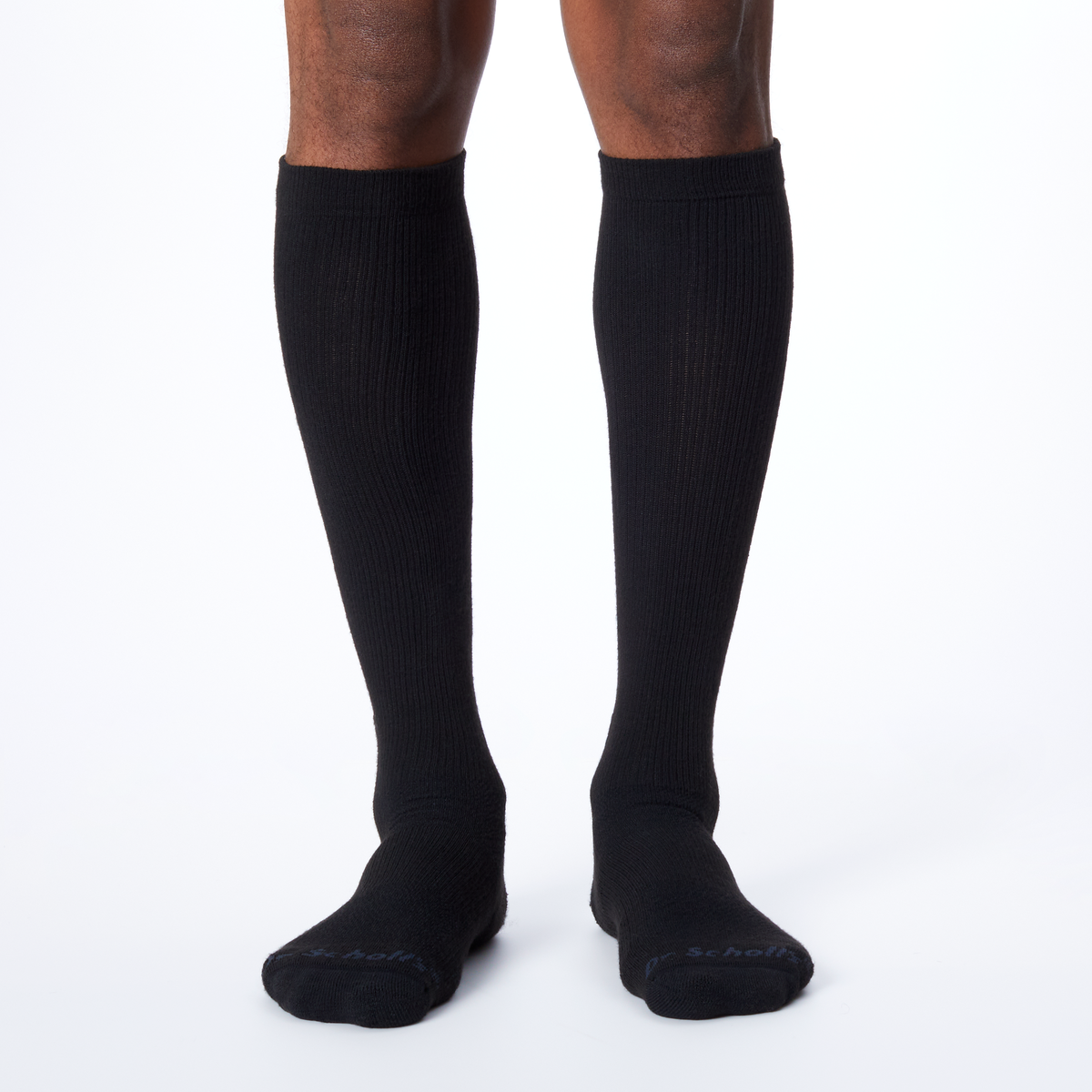 Front profile of a man wearing knee high Dr. Scholl's socks