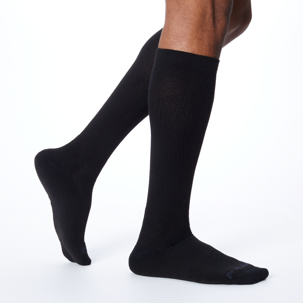 Side profile of a man wearing knee high Dr. Scholl's socks