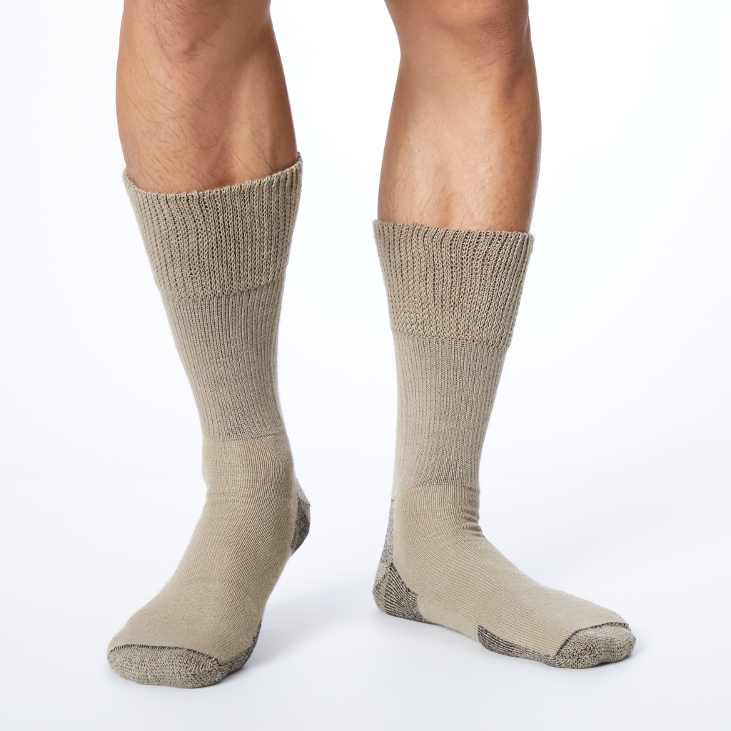 Back profile of a man wearing beige Dr. Scholl's crew socks with gray accents at the heel and toe.