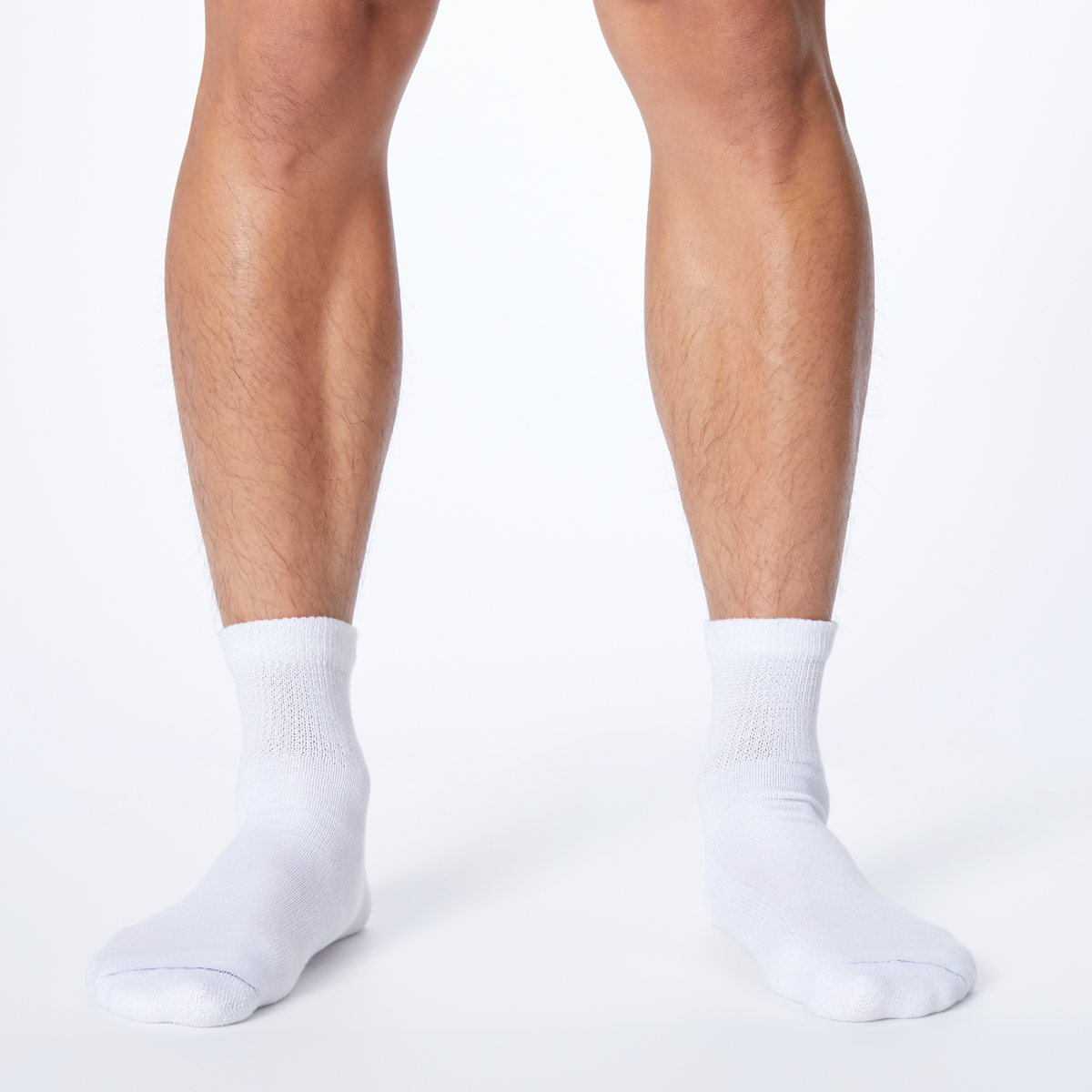 Front profile of a man wearing white Dr. Scholl's quarter socks.