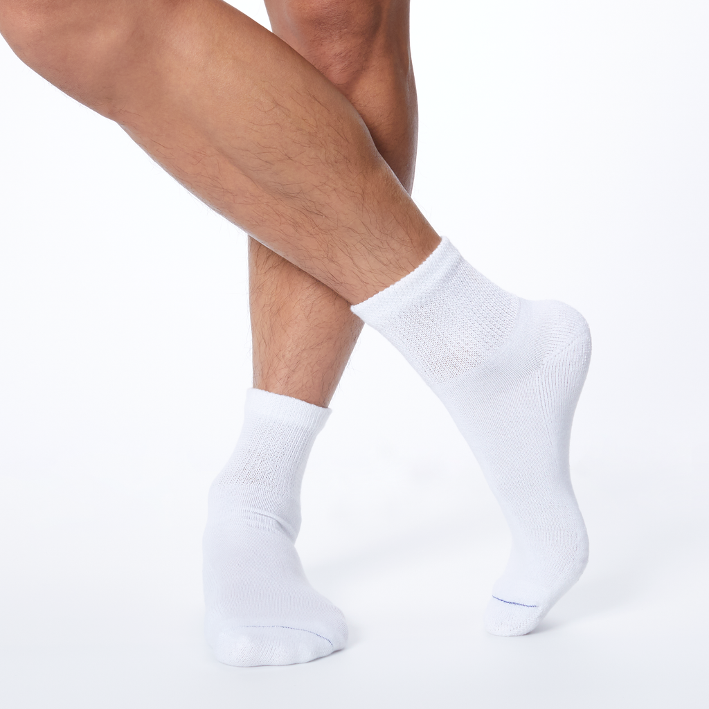 Front profile of a man wearing white Dr. Scholl's quarter socks.