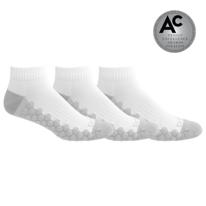 Three white ankle socks with gray grip patterns on the sole and heel, arranged in a row on a white background with a silver 'Design Excellence Awards Finalist' badge in the top right corner.