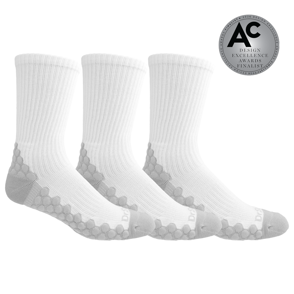 Three pairs of white crew socks with gray honeycomb patterned heels and toes, displayed on a clean white background with an 'AC Design Excellence Awards Finalist' badge in the top right corner.