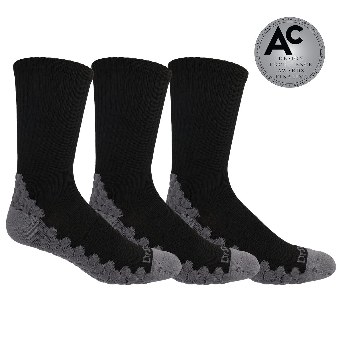 Three black crew socks with gray textured grip zones and gray toes, shown on a white background with a silver award badge in the top right.