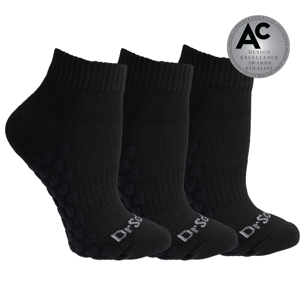 Three black ankle socks arranged in a fan shape on a white background, with textured grip dots on the soles and white 'Dr.SS' branding on the toes.