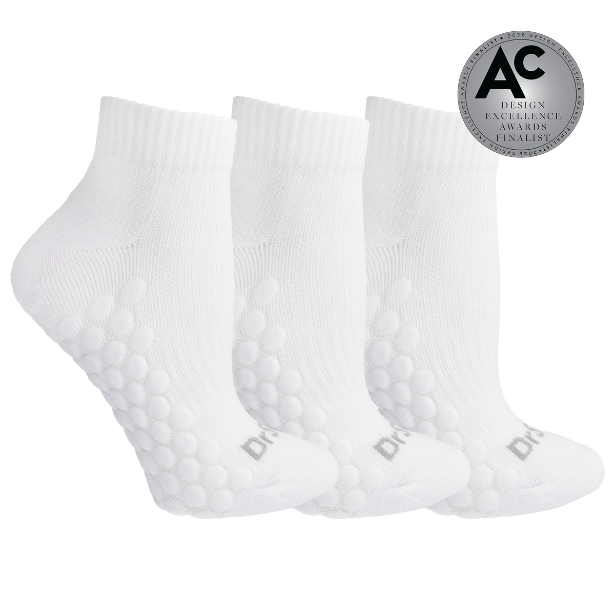 Three white ankle socks with raised bubble grip panels on the sole, shown on a white background with a silver award badge in the top right.