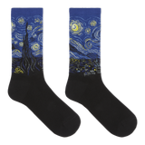 A pair of crew socks with a black lower half and a blue cuff printed with a Van Gogh-inspired swirling night sky design in yellow, white, and black.