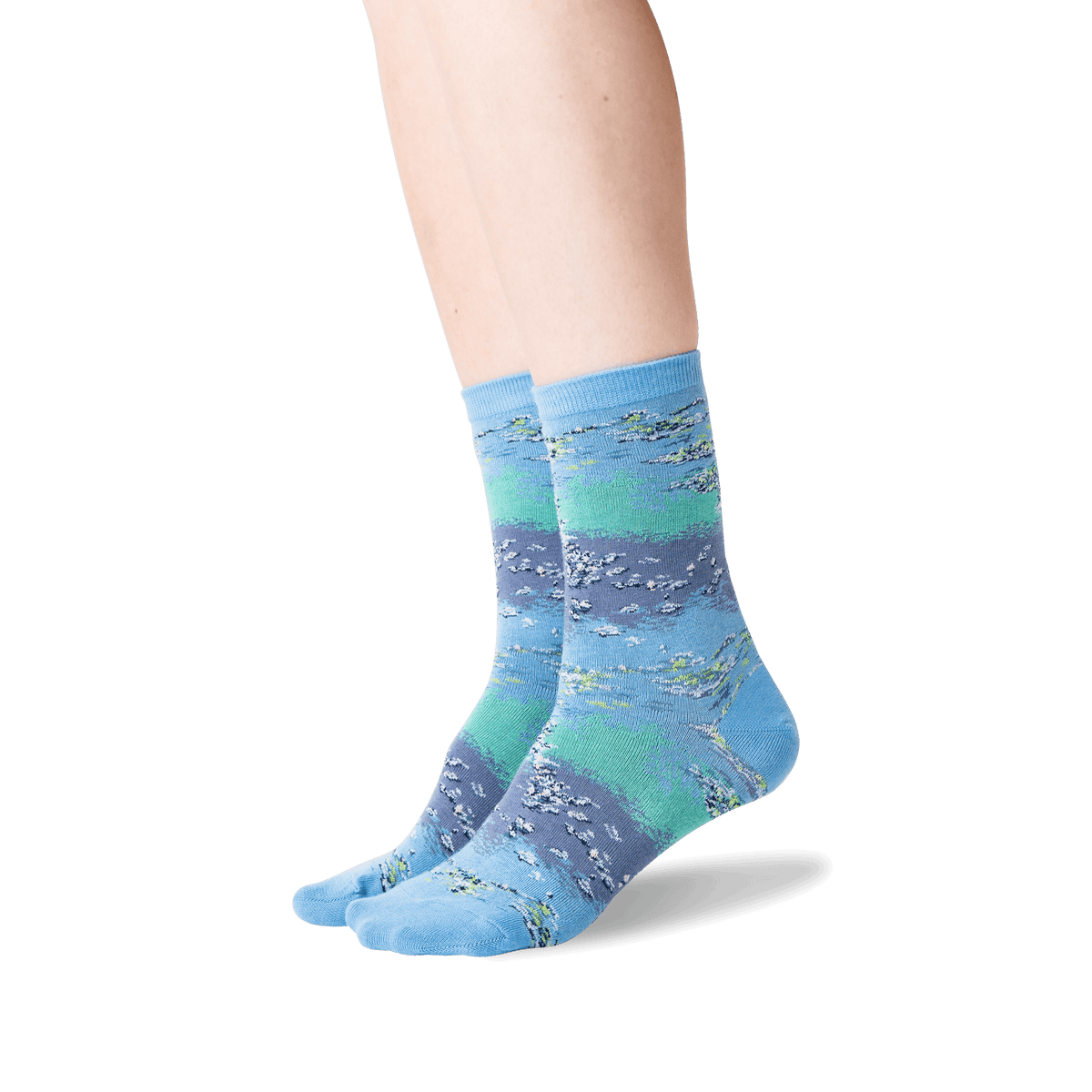 A pair of crew socks with a horizontal striped pattern in shades of blue, teal, and purple, featuring a fish design, shown on a model's feet against a white background.