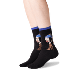 A pair of black crew socks worn on a person's feet, featuring a graphic print of Vermeer's Girl with a Pearl Necklace in blue, brown, white, and red tones, with solid blue ribbed cuffs.