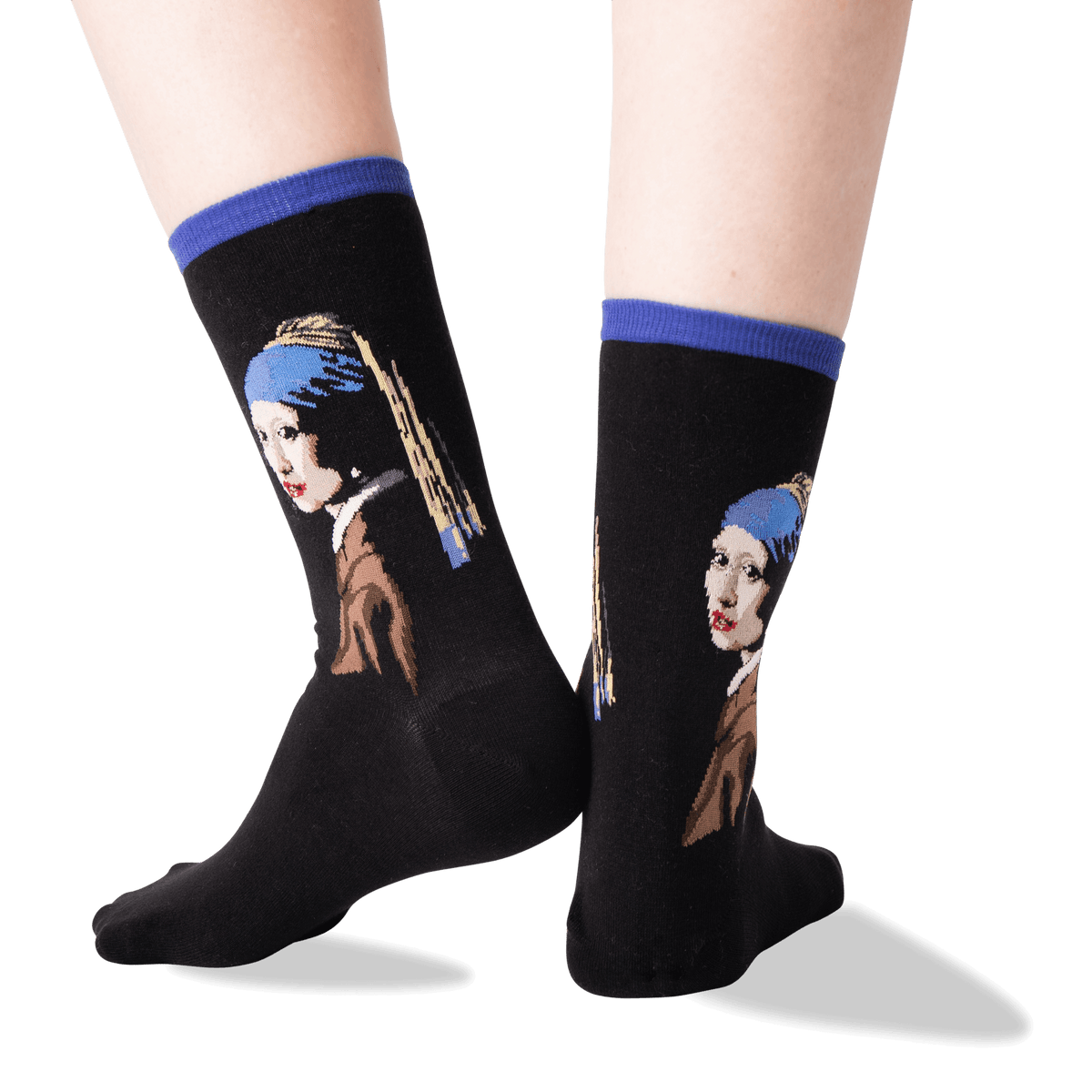 A pair of black crew socks with blue ribbed cuffs, featuring a printed portrait of Vermeer's Girl with a Pearl Necklace on the sides, shown on a person's feet against a white background.