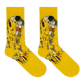 A pair of bright yellow crew socks featuring a printed art design inspired by Gustav Klimt's 'The Kiss', shown against a plain white background.