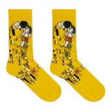 A pair of bright yellow crew socks featuring a printed art design inspired by Gustav Klimt's 'The Kiss', shown against a plain white background. thumbnail
