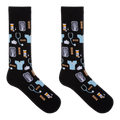 A pair of black crew socks with a medical-themed pattern featuring light blue scrubs, stethoscopes, X-ray images, pills, and hands, displayed against a solid white background.