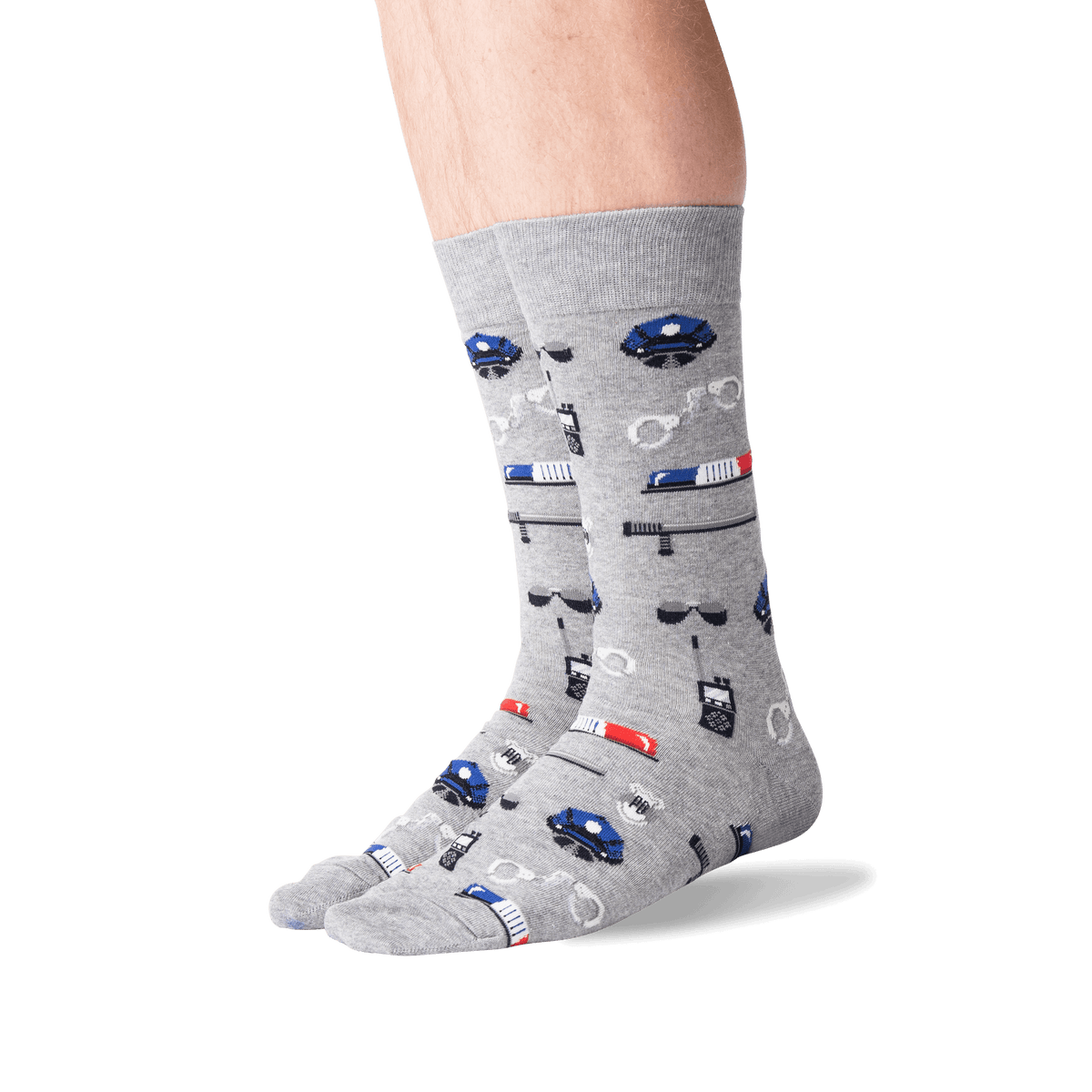 A pair of crew socks worn on a person's feet, featuring a gray heather base with a repeating pattern of blue and red police cars, sirens, and badges.