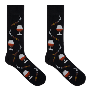 A pair of black crew socks with a repeating pattern of cognac whiskey glasses, cigars, and smoking pipes, displayed flat against a solid white background.