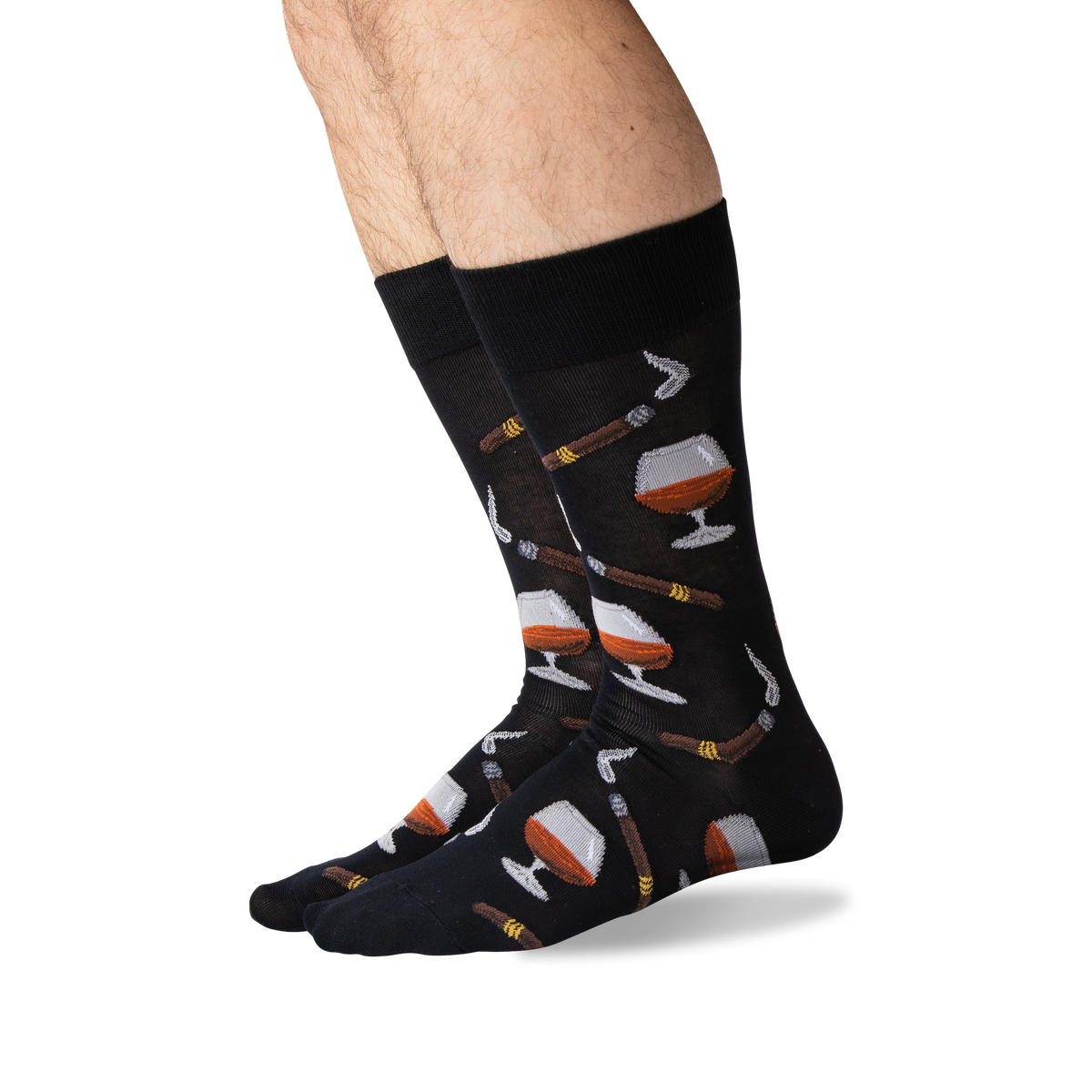 A pair of black crew socks with a pattern of whiskey glasses, cigars, and cigars being lit by matches, shown on a person's legs against a white background.