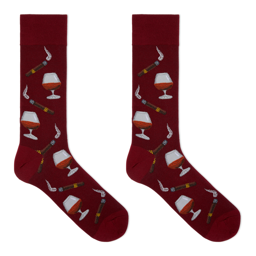 A pair of crew socks in deep burgundy with a repeating pattern of cigars, smoking pipes, and cognac glasses filled with amber liquid, shown on a plain white background.