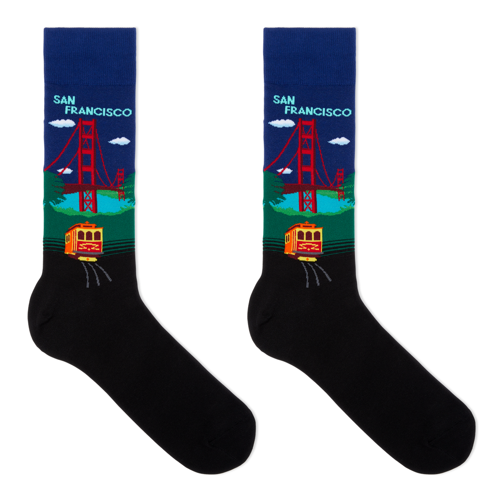 A pair of black crew socks with a colorful San Francisco graphic on the upper leg. The design features the Golden Gate Bridge, a yellow cable car, and the text 'SAN FRANCISCO' on a dark blue background, with a black lower section.