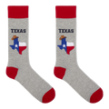 A pair of crew socks in heather gray with red cuffs, heels, and toes. Each sock features a graphic of the state of Texas filled with the Texas flag and a small cowboy hat, with the word 'TEXAS' printed above in dark blue.