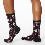 Woman wearing black socks with wine-themed pattern on a white background thumbnail