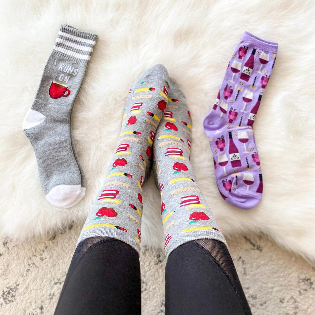 Three pairs of patterned socks on a white surface