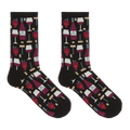 A pair of crew socks on a plain white background, featuring a black base with a repeating pattern of red wine bottles, wine glasses, corkscrews, and red raspberries.