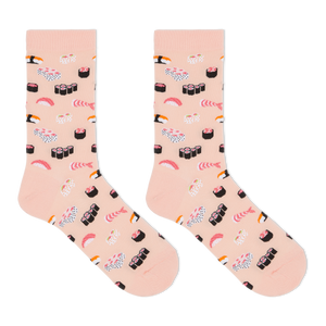 A pair of crew socks in a light peach-pink color, printed with a playful pattern of various sushi and sashimi illustrations, shown against a plain white background.