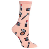 A single light pink crew sock with a repeating pattern of various makeup items, including lipstick, eyeshadow palettes, brushes, and mirrors, shown on a plain white background. thumbnail