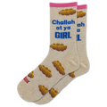 A pair of beige crew socks with a pink cuff, featuring a pattern of braided bread loops and blue text that reads 'Challah at ya GIRL'. One sock also has red text reading 'Sax' near the toe.