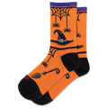 A pair of orange crew socks with a Halloween theme, featuring black heels, toes, and cuffs, decorated with a witch's hat, broomstick, spiderwebs, and spiders.