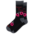A pair of black crew socks with gray heels, toes, and cuffs, featuring pink and red graphic prints of handcuffs and the text 'Partner in Crime'.