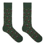 A pair of dark green crew socks with an all-over golf course pattern featuring red and white golf carts, golf balls, flags, and a golfer, displayed against a solid white background.