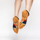 Colorful socks with abstract Kandinsky design worn by a person on a white background