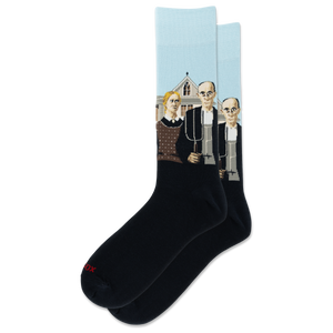 A pair of crew socks on a plain white background. The socks are black with Grant Woods' "American Gothic" on a light blue background, and a small red 'HOTSOX' logo near the toe.