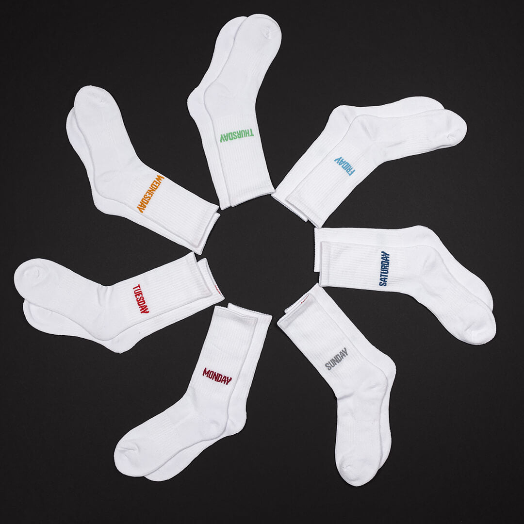White socks with days of the week text on a black background