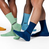 Three pairs of socks labeled 'Thursday', 'Friday', and 'Saturday' worn by different people on a white background.