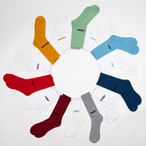 Assorted colorful socks arranged in a circular pattern on a white background
