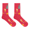 A pair of bright pink crew socks featuring a festive champagne-themed print with orange slices, champagne glasses, and a green champagne bottle, displayed against a solid white background.