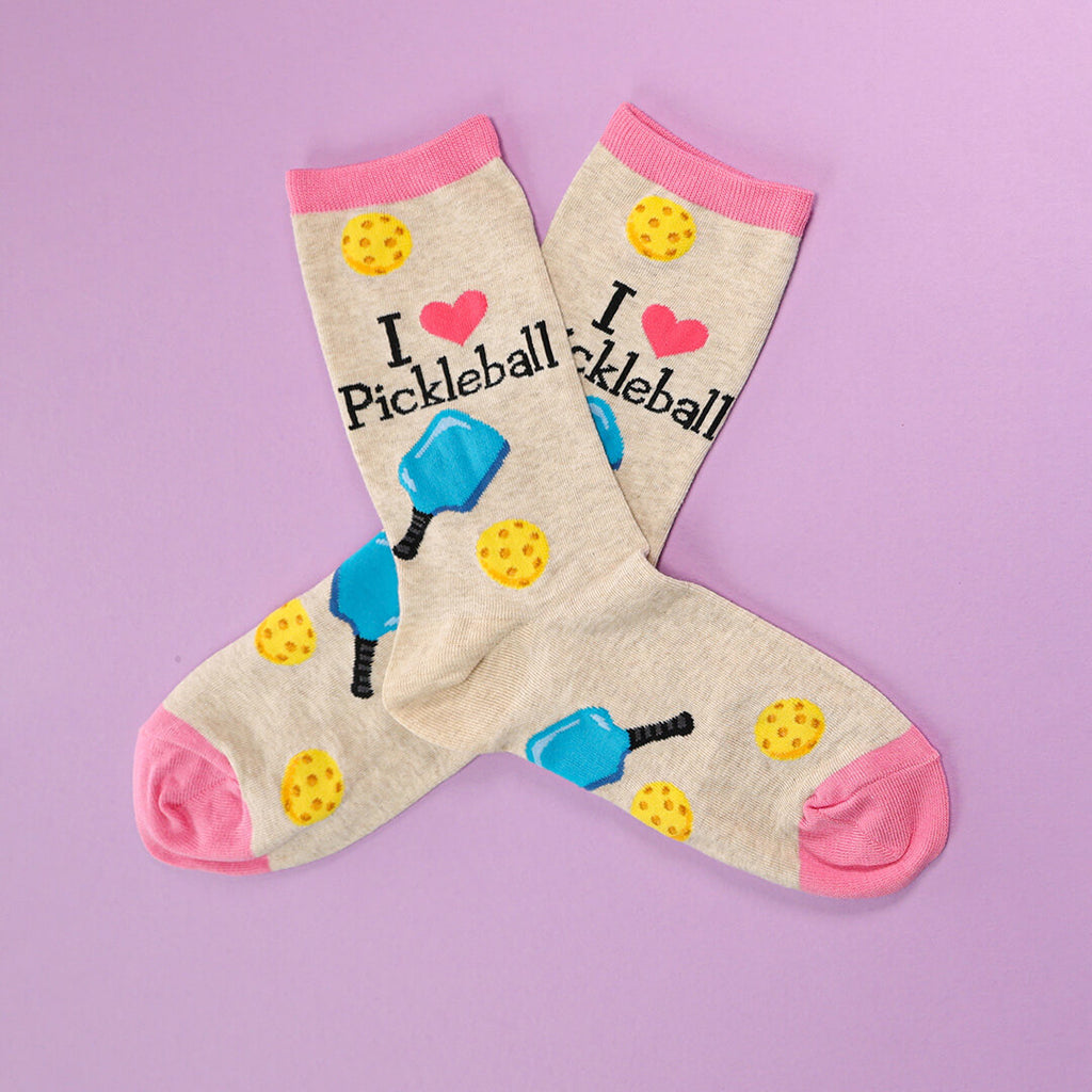 Pickleball-themed socks with graphics and text on a purple background