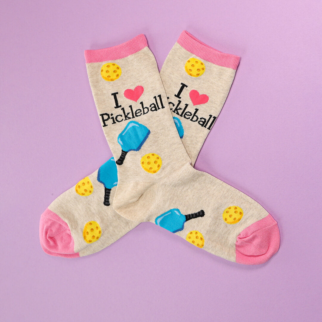 Pickleball-themed socks with graphics and text on a purple background