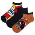 Three pairs of women's ankle socks with abstract geometric patterns in a variety of colors, positioned side by side.