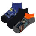 Three pairs of socks with artistic designs on a white background