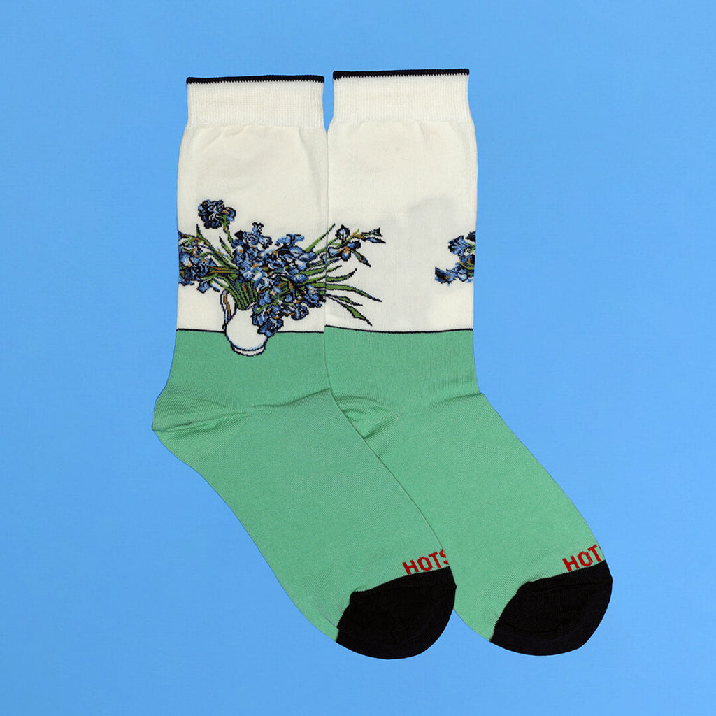 Green socks with floral 'Irises' design by Van Gogh on a blue background