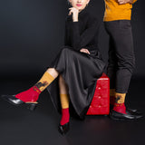 Person wearing black dress and red shoes with a black background thumbnail