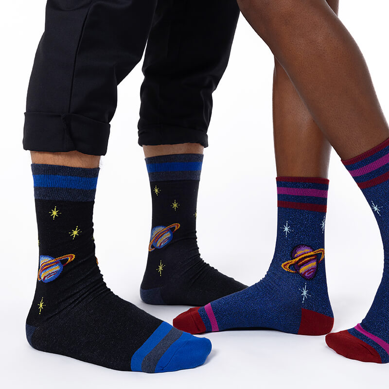 Two pairs of socks with space-themed designs on a white background