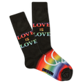 A pair of men's crew socks with the phrase 'love is love' printed in colorful letters on a black background, and a rainbow stripe design at the cuff.