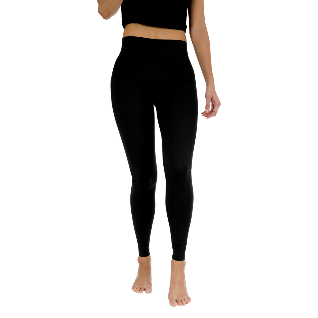 Person wearing black leggings on a white background