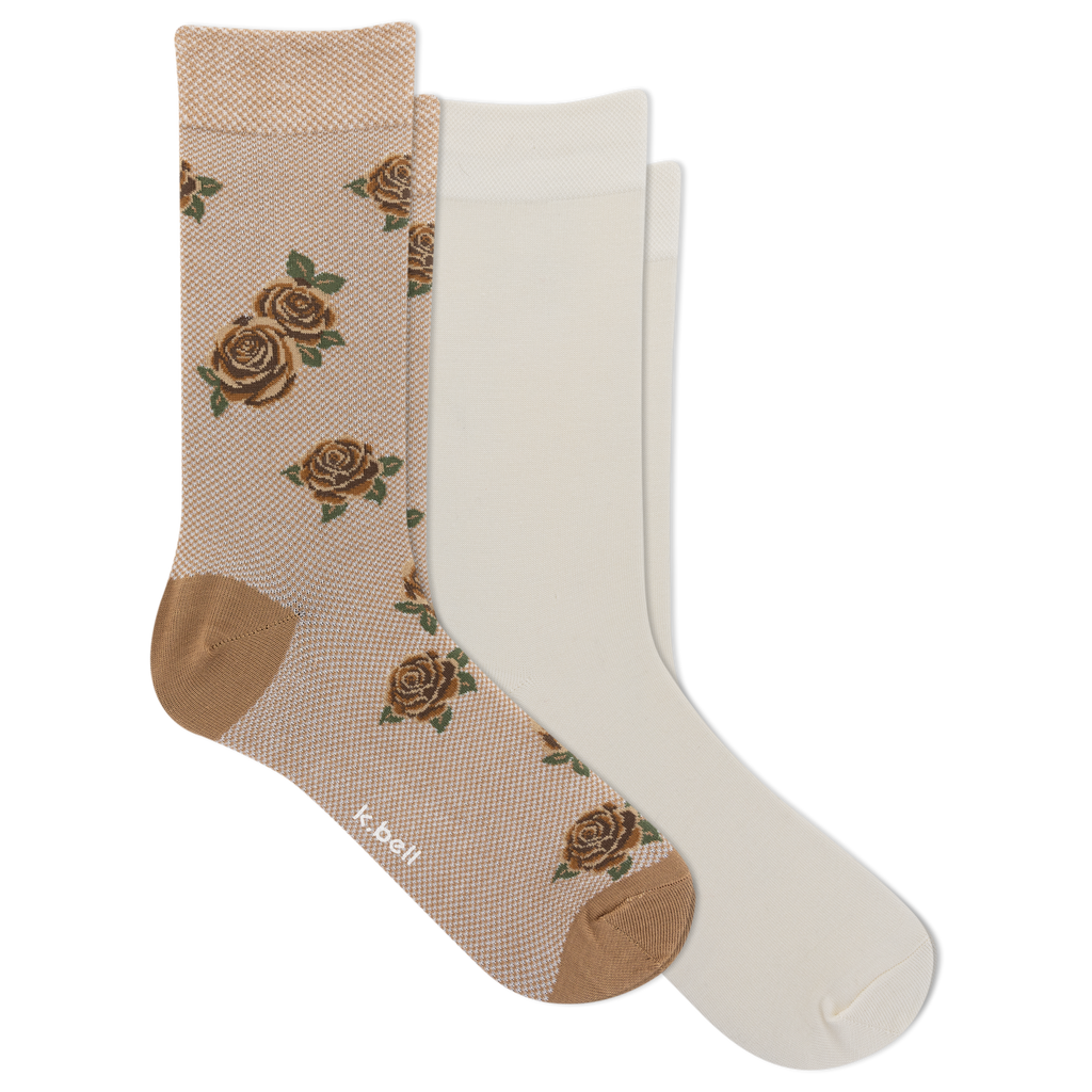 Two pairs of crew socks on a plain white background: one pair is beige with a brown rose pattern and tan heel/toe areas, and the other pair is solid off-white. The brand name 'k-ball' is visible on the patterned sock.